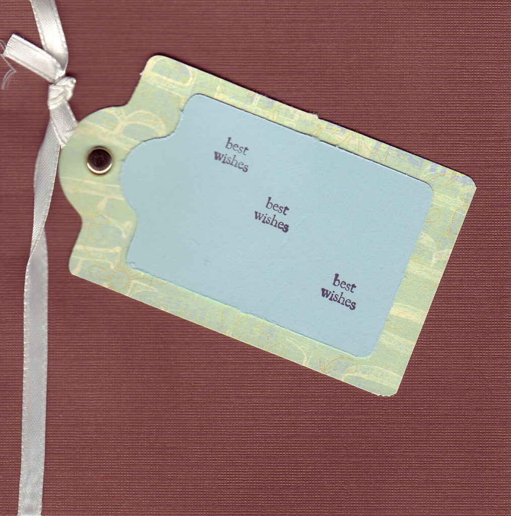 155 - 'Best Wishes' on a tag on deep maroon paper