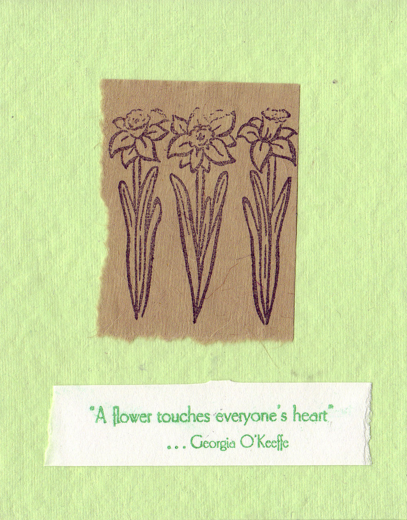 211 - 'A flower touches everyone's heart' with daffodil stamps on brown paper on a soft green textured card
