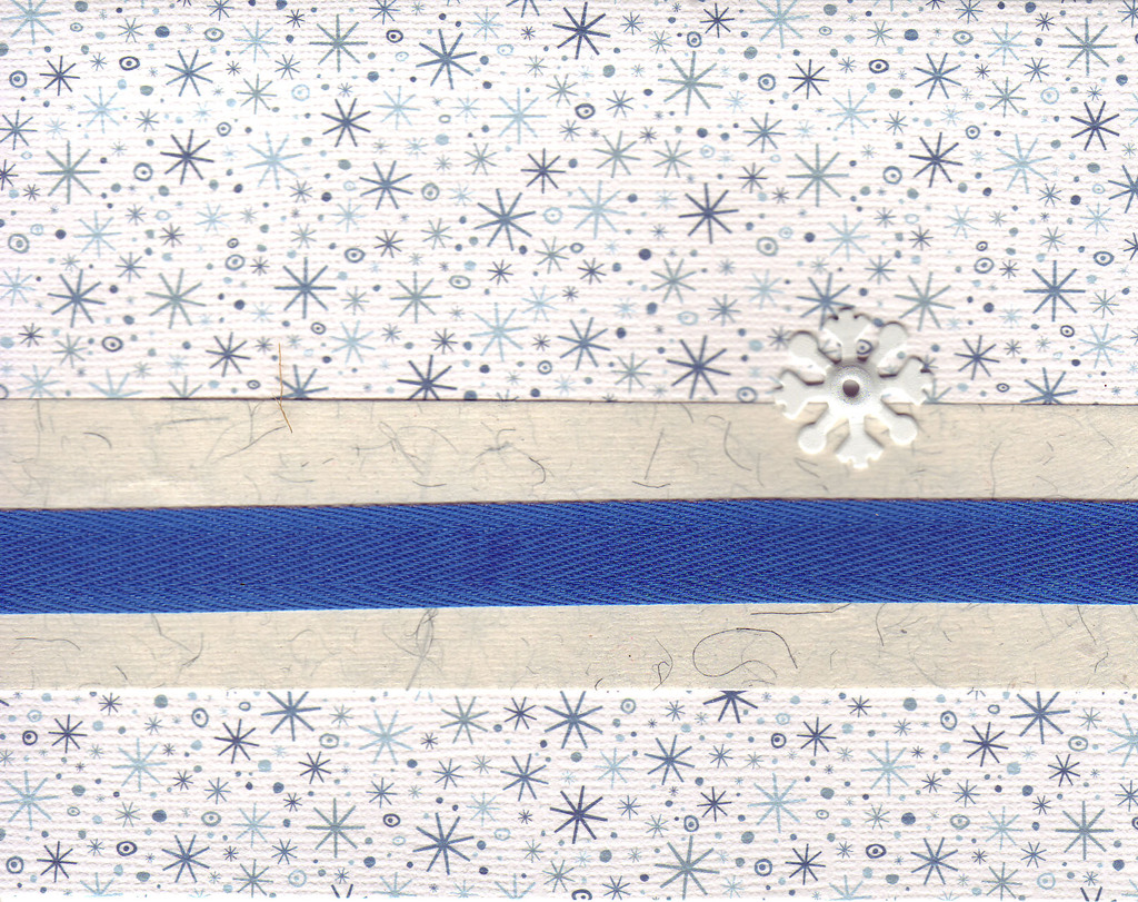 070 - A blue ribbon attached to a snowflake card by a metal snowflake brad