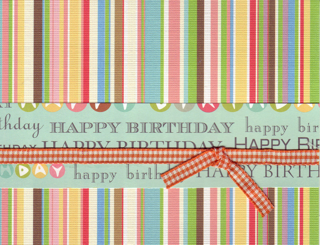 009 - 'Happy Birthday' on festive striped paper with ribbon