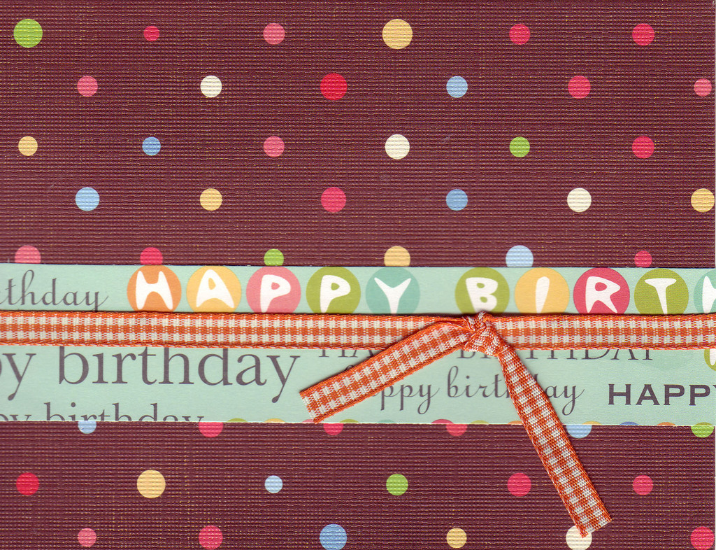 010 - 'Happy Birthday' on festive polka dotted paper with ribbon