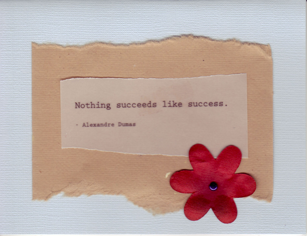 078 - 'Nothing succeeds like success' on brown and lavender paper with red flower