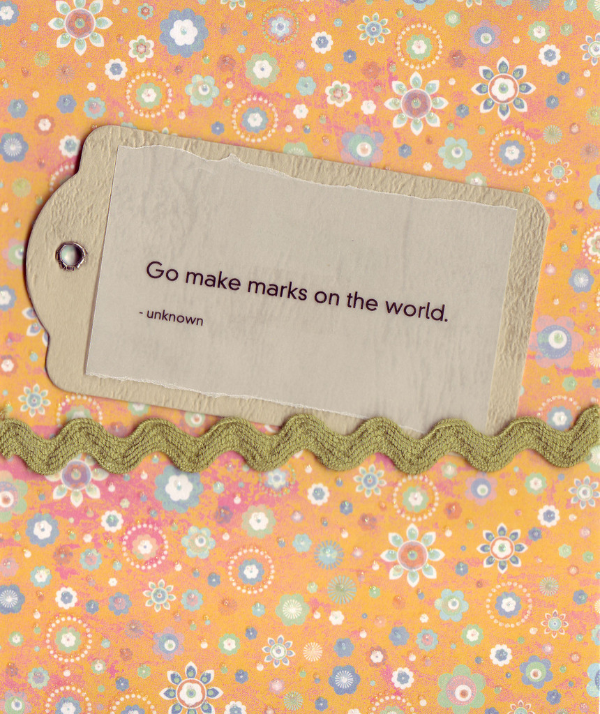 131 - 'Go make marks on the world' on a tan tag, with a wavy green ribbon on a whimsically floral-patterend orange card