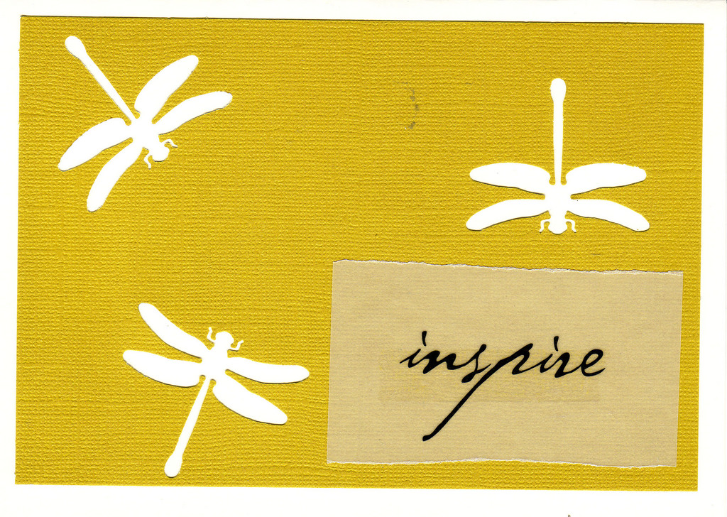 150 - 'Inspire' atop yellow paper with dragonfly cutouts on a white card